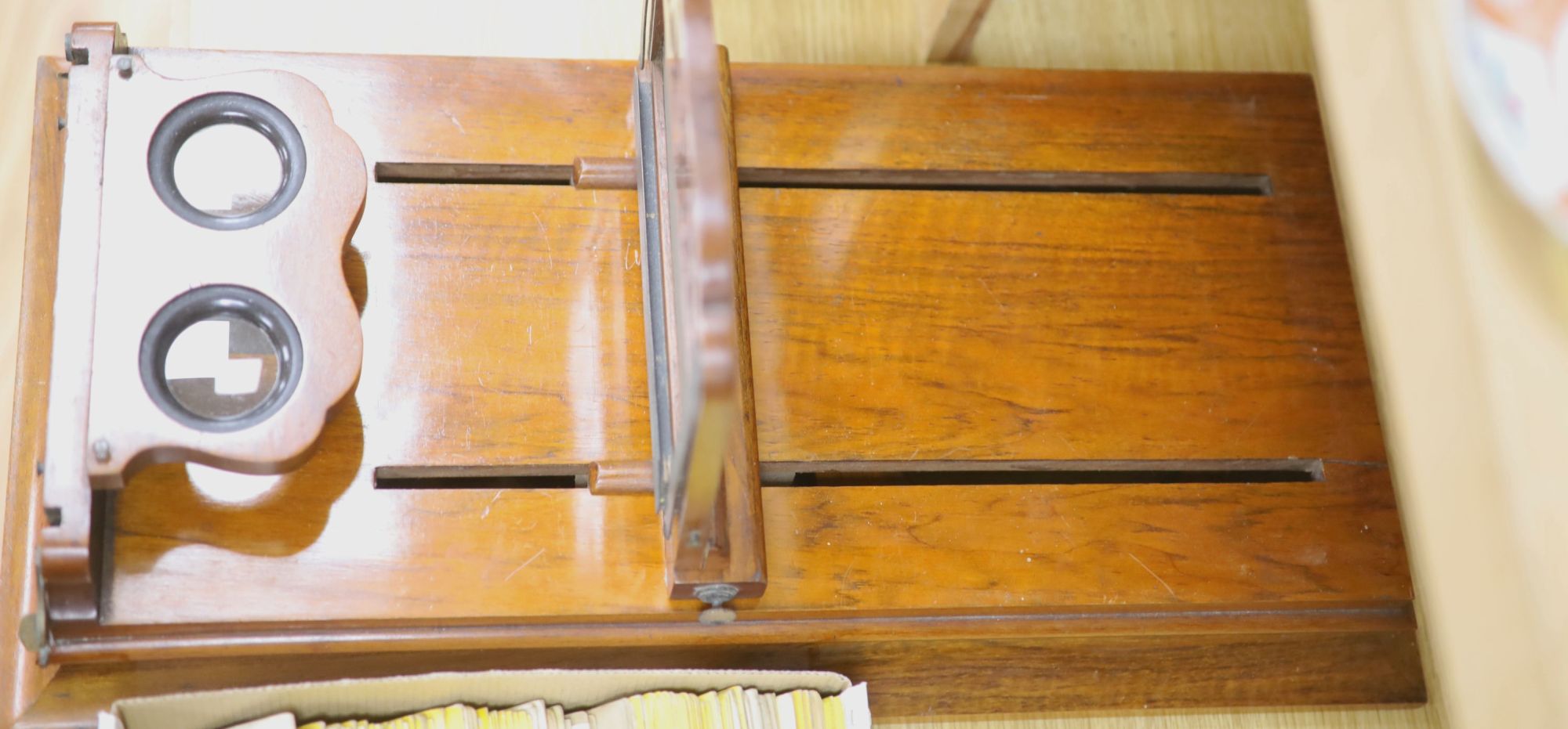 A large Victorian walnut stereoscopic card viewer with slides, Football at Eton etc, length 58cm width 30cm height 28cm